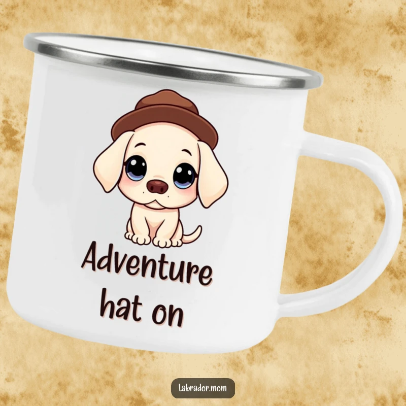 Funny enamel camping mug featuring a Kawaii Labrador with big, innocent eyes balancing a hat, perfect for humorous outdoor sipping.