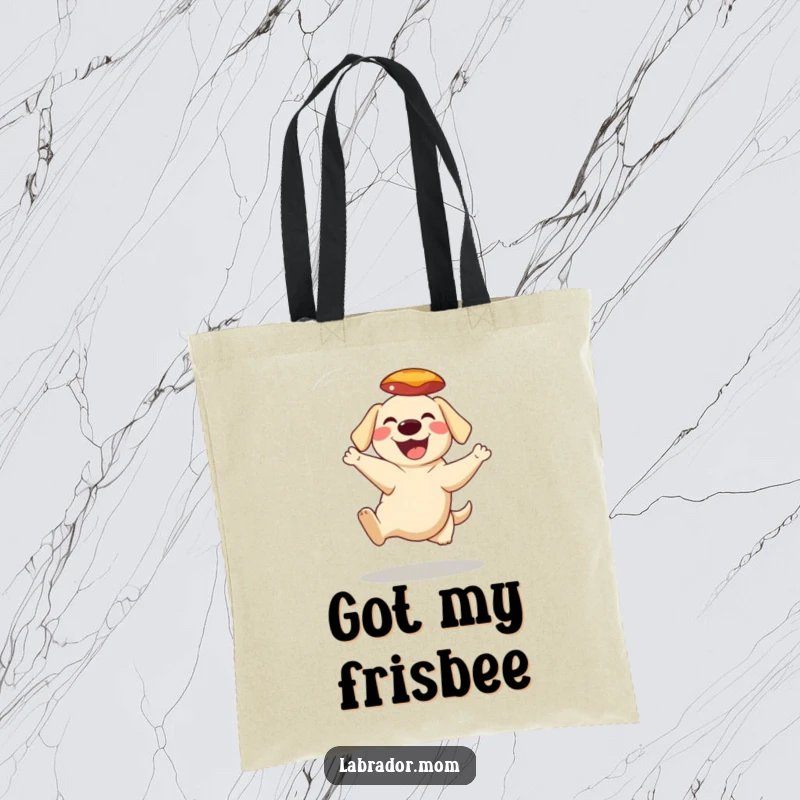 Funny Tote Bag with a grinning Labrador character expertly catching a frisbee mid-air, perfect for park trips and errands.